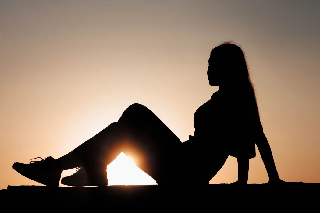 Two people sharing an intimate moment in silhouette